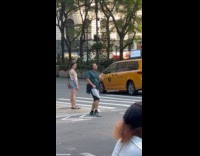 Man wearing headphones dancing and singing on crosswalk