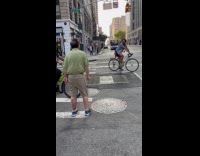 Man points and yells at cyclist street