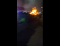 Collab IITW - Woman poses beside the dumpster on fire