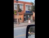 Woman green top brown jogging pants closed store