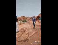 Girl poses for photo in middle of canyon