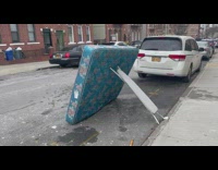 Ironing board holds up the mattress on the street
