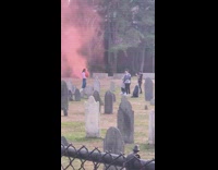 Guy hold halloween pumpkin pink smoke cemetery