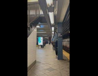 Guy wearing flannel does pull ups at subway station 
