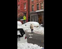 Lady uses mop to shovel snow car