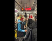 Band singing Feliz Navidad on subway