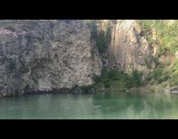 Guy jumps off cliff into water