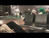 Girl poses on conveyer belt at airport