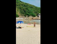 Woman get held upside down at beach 