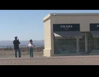 Woman in cowboy hat does dance in front of Prada store 