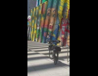Woman in white crop top dances in front of mural painting