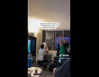 Couple dancing with orange cat holding up arms