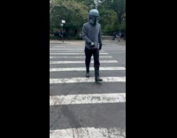 Guy cross the street wear Mandalorian helmet