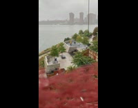 Yellow raincoat pants person exercises elliptical machine 