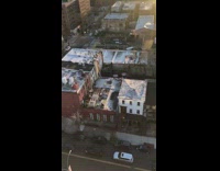 Two guys practice fighting outside on rooftop 
