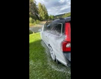 Satisfying car wash soap sprayed on van