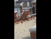 Woman blue bikini hat beach ben umbrella