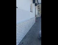 Guy jumps over man sitting on sidewalk