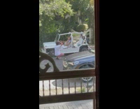 Mother and daughter ride on small jeep