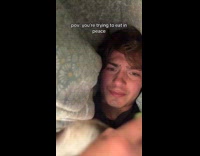 Man eating sandwich hiding from dog 