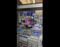 Man kicks and catches fallen product item on the store