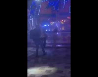 Couple dance beside spinning theme park ride