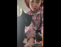 Girl shows cat her ID 