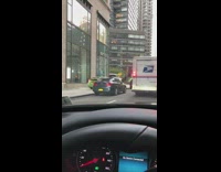 green taxi cab drives sidewalk mail truck  