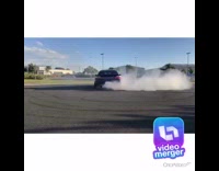 Blue sedan car does donuts on asphalt 