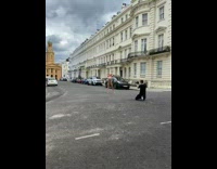 Bikini girl stands street brown church building 