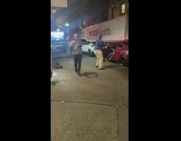 Dance with a random man along street corner in NY 