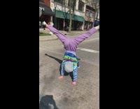 Girl grandma costume cartwheels across crosswalk wig
