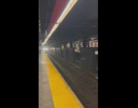Man sitting on train tracks