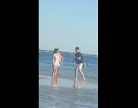 Guy fixes pose before photographing girl beach 