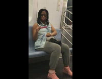 Pregnant women files her fingernails with pink nail filer on the subway