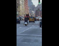 Guy rides jetski on wheels down street 