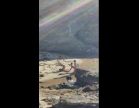 Three men in briefs crawls on the beach