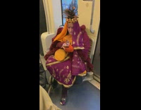 Lady wears traditional clothes on subway 