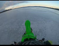 POV of guy on dirt bike riding on frozen lake