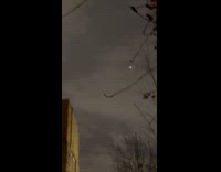 Large drone flies around at night sky