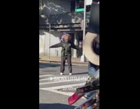 Man dance at day along the street in NY 