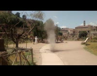 Guy laughs at small dirt tornado outside 