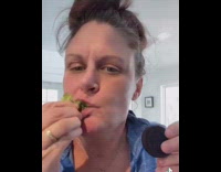 Lady sniffs oreo while eating broccoli 