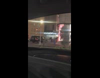 person in sparkle jacket and feather head band