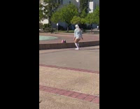 Woman in jean jacket tiktok dance by the fountain
