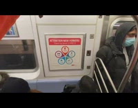Crowded subway PSA sign stop coronavirus spread