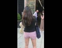 Guy leads llama alpaca into black building