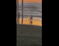 Girl hold burning newspaper beach sunset chair