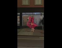 Guy walking down sidewalk wears flamingo costume 
