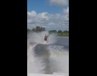 Water Skiier Raises Fist in Air and It Causes Him to Faceplant